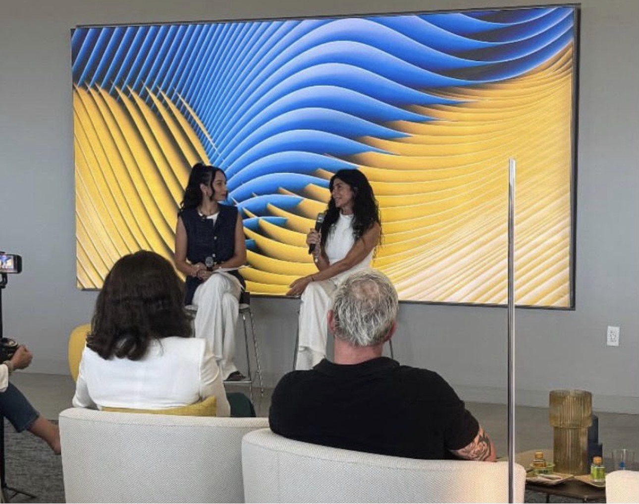 Stefania Sorrenti speaking with a microphone during an on-stage conversation